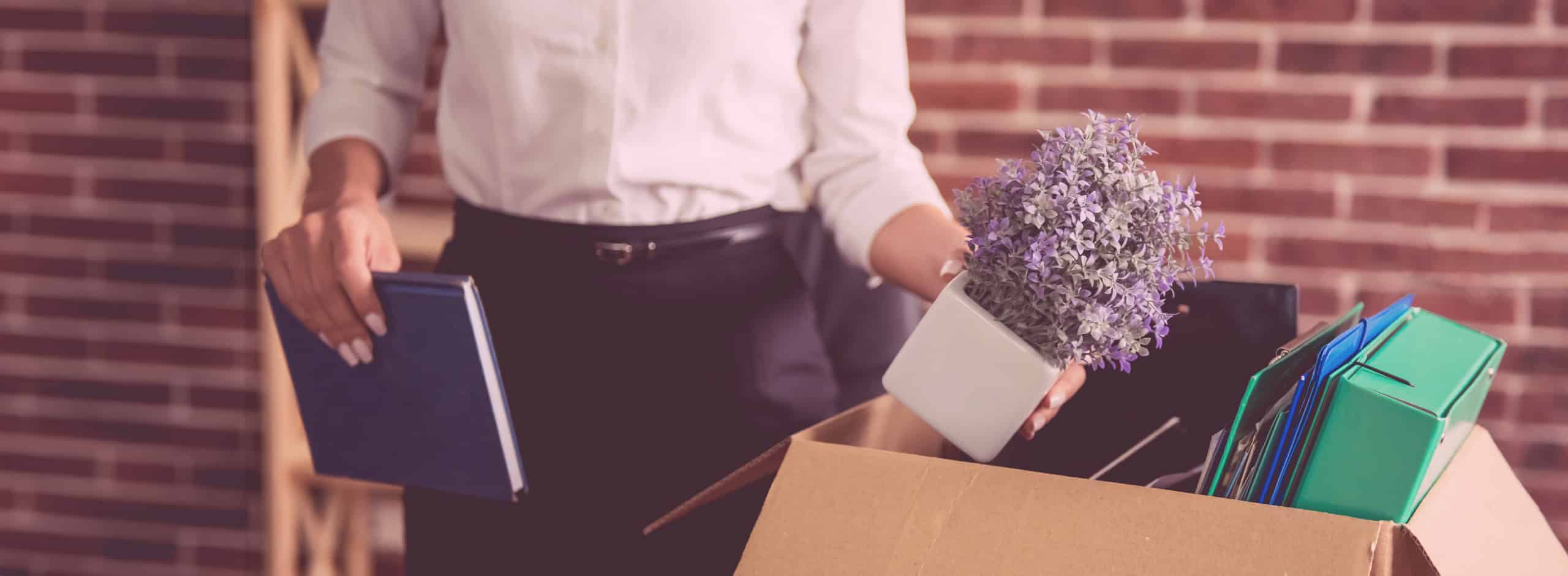 Woman packing a box at work, wrongful termination