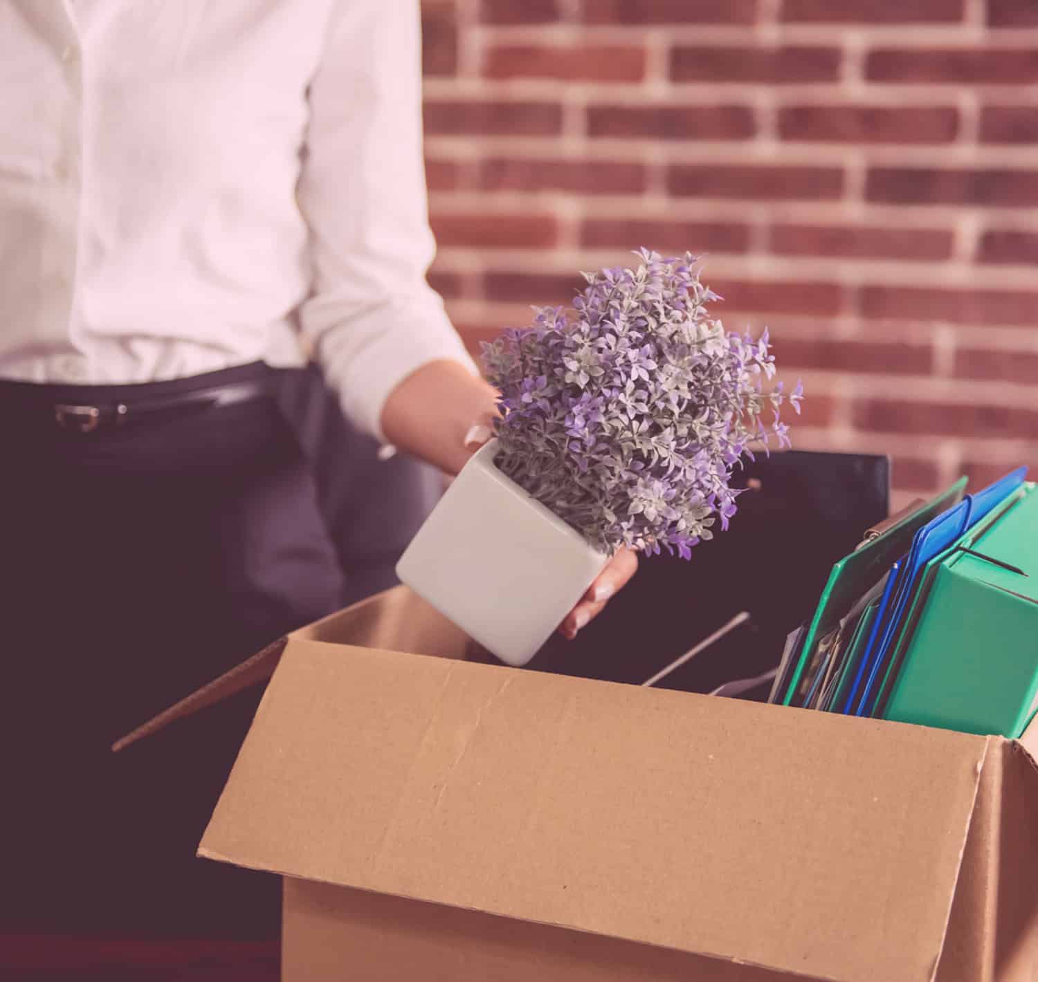 Woman packing a box at work, wrongful termination