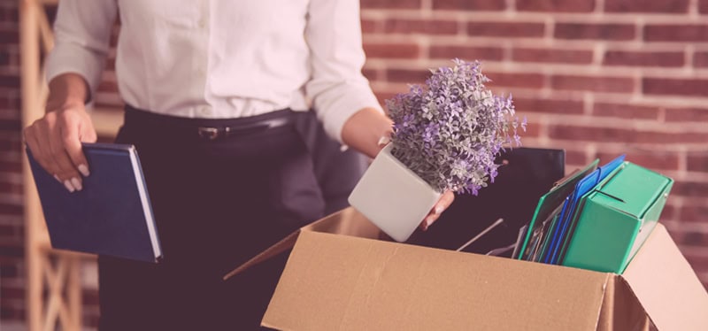 Woman packing a box at work, wrongful termination